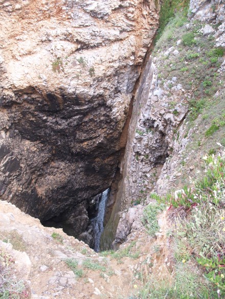 Figure 78 - Blow hole in a limestone sequence (Praia da Adraga, Portugal).
